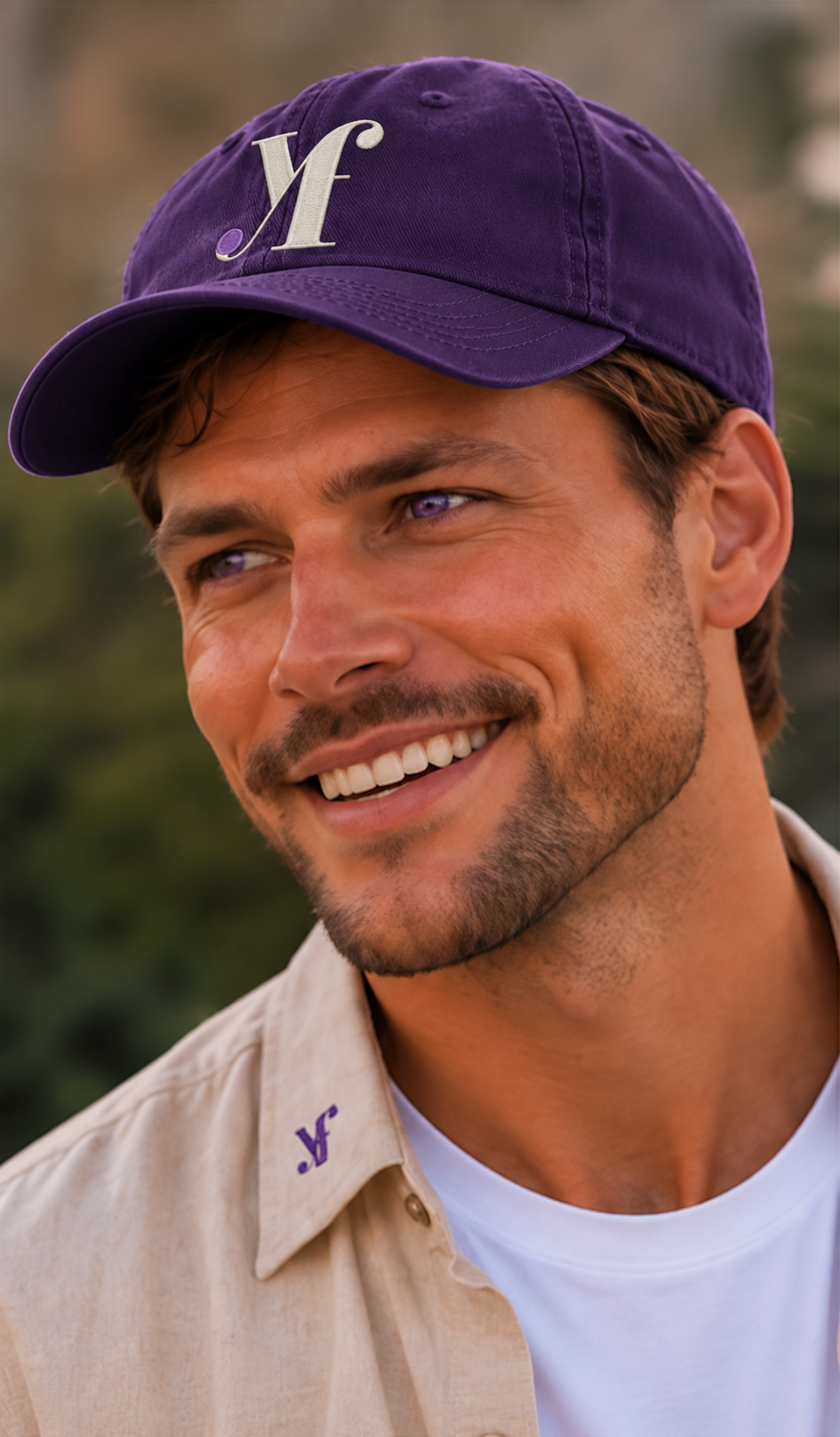 Ethan wearing a purple YourFaiv cap with the Yf monogram, smiling outdoors